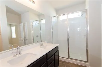 a bathroom with a double vanity sink and mirror