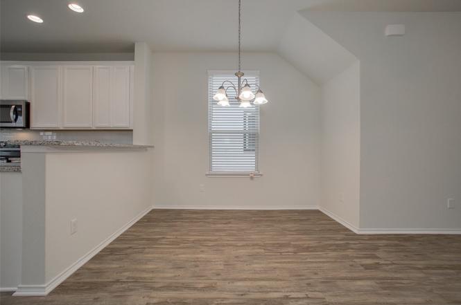 148 Spotted Rail Ridge Leander, TX 78641 - Photo 9 of 31 A refined dining space connects seamlessly with the kitchen, creating an inviting atmosphere.