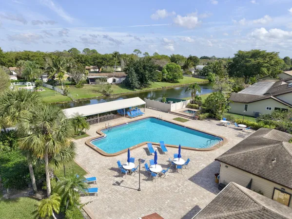 an aerial view of a swimming pool and lake view