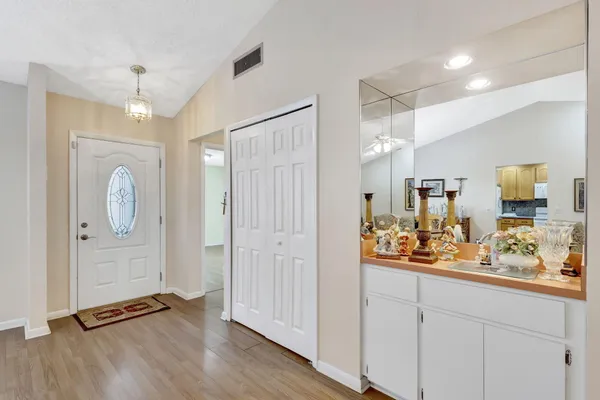 a view of a hallway with wooden floor and staircase