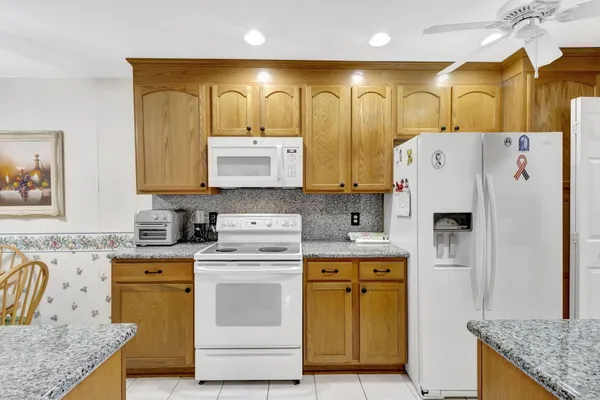 a kitchen with cabinets appliances and a counter
