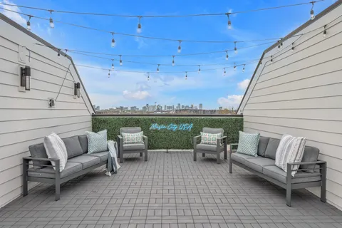 a view of a terrace with furniture and a potted plant