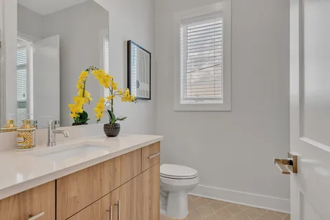 a bathroom with a sink a toilet and mirror
