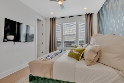 a bedroom with a bed and a flat screen tv