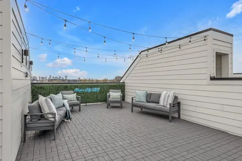 a view of a patio with couches chairs and potted plants
