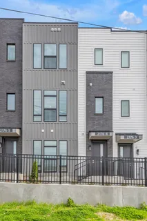 a view of a house with a small yard and wooden floor and fence