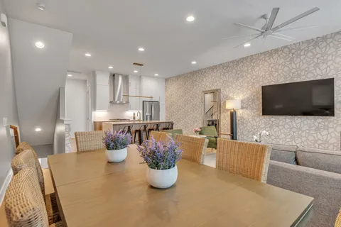 a dining room with furniture and a flat screen tv