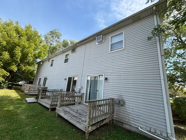 a view of a chair and tables the back yard of the house