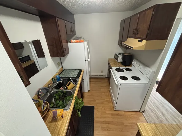 a view of living room with furniture and a fireplace