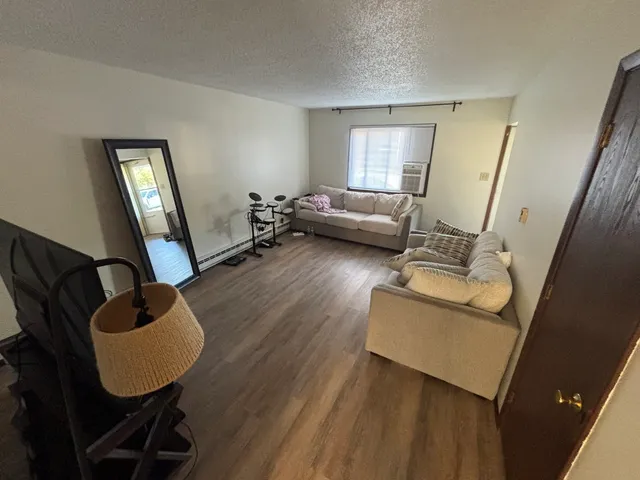 a living room with furniture and a mirror