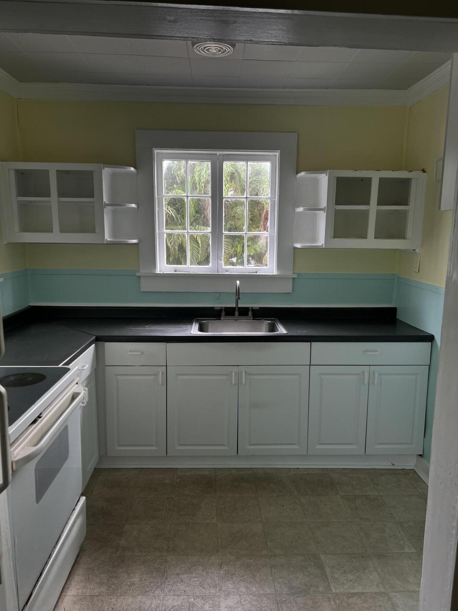1115 Fleming Street Key West, FL 33040 - Photo 14 of 31 a kitchen with a sink and cabinets