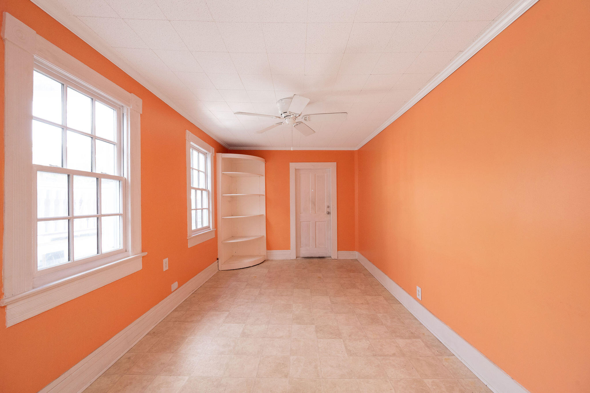 1115 Fleming Street Key West, FL 33040 - Photo 25 of 31 an empty room with windows and chandelier fan