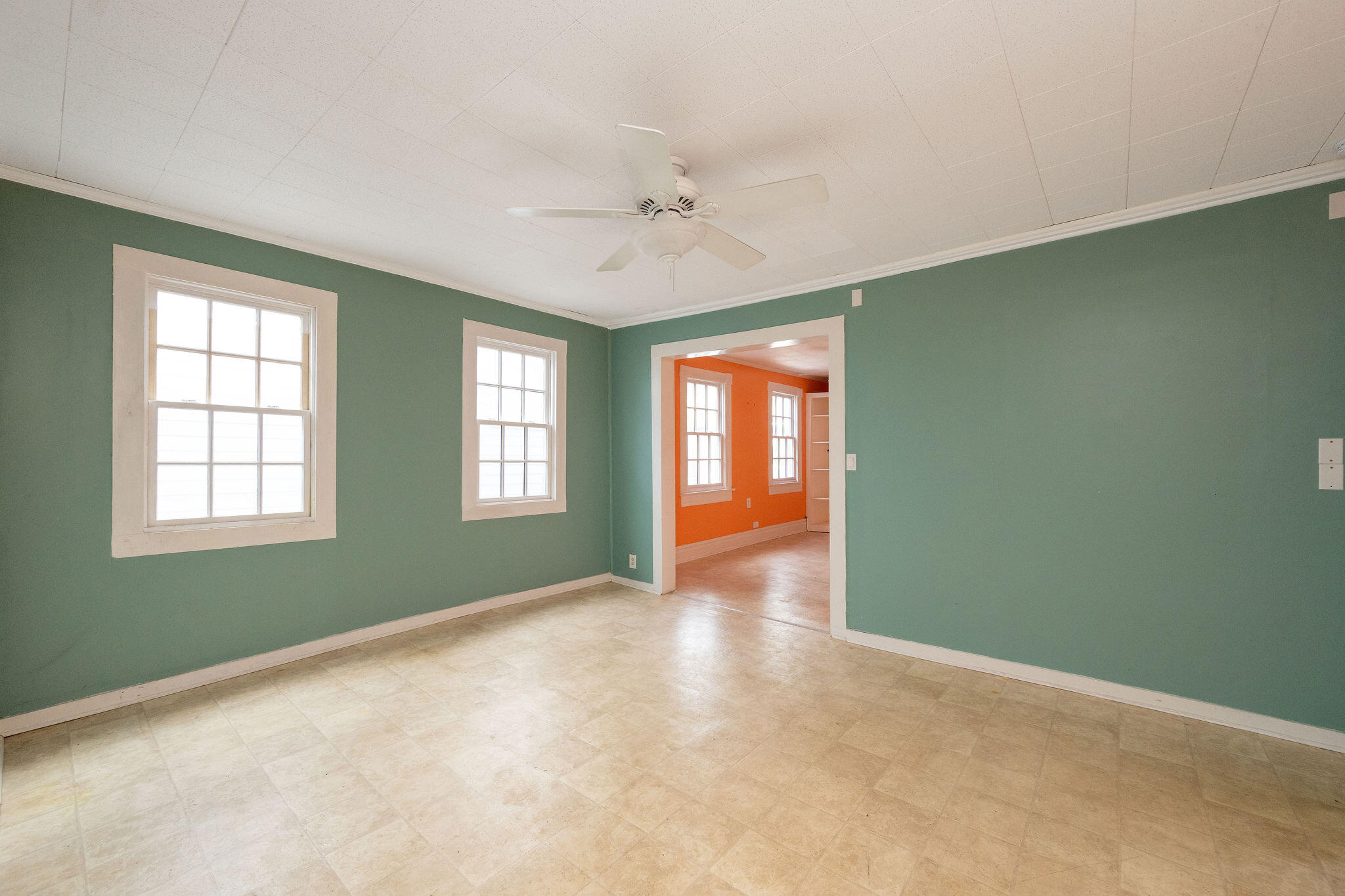 1115 Fleming Street Key West, FL 33040 - Photo 27 of 31 an empty room with chandelier fan and windows