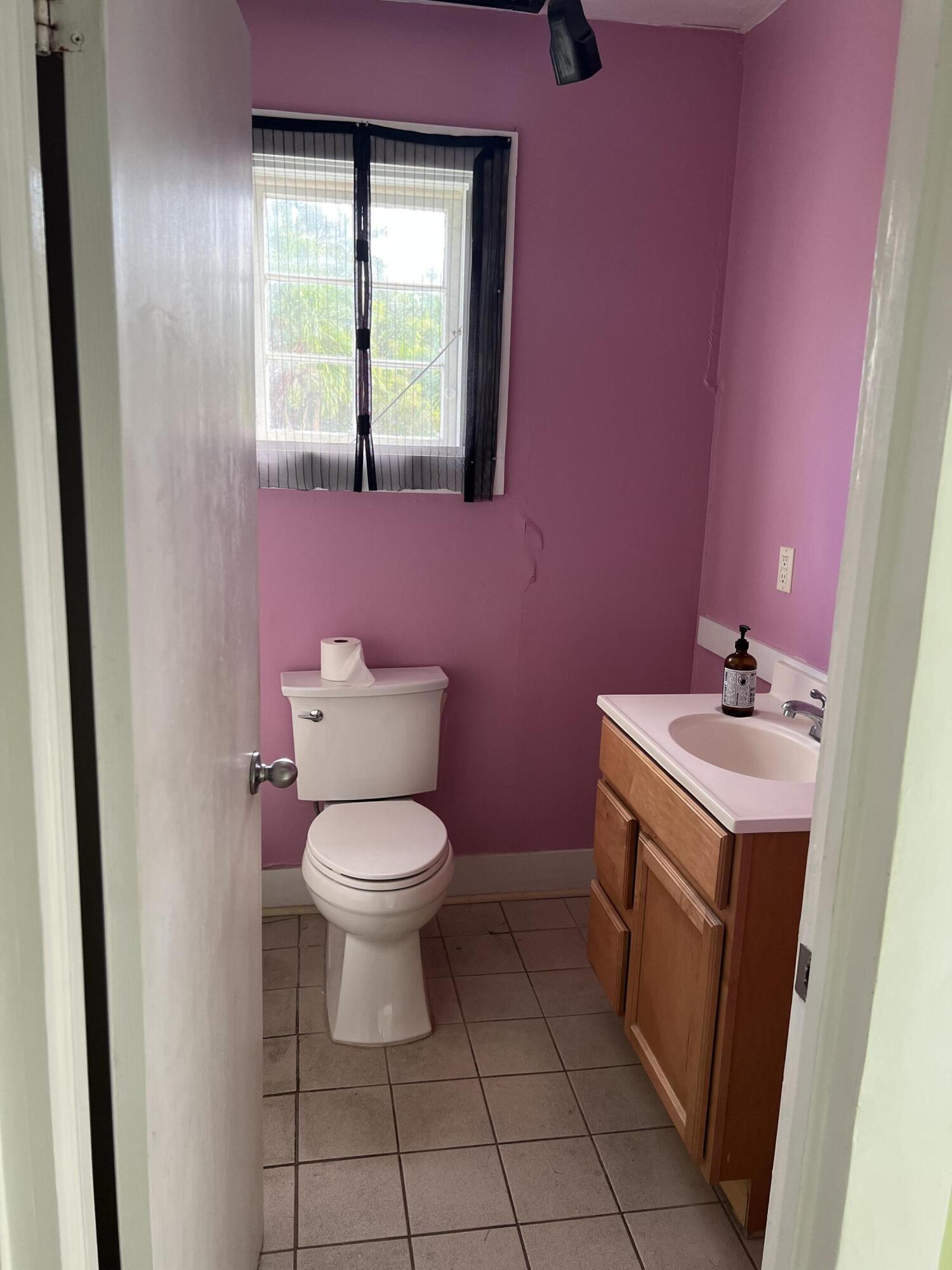 1115 Fleming Street Key West, FL 33040 - Photo 9 of 31 a bathroom with a sink toilet and window
