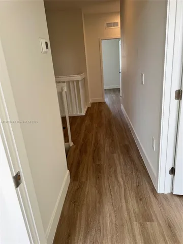 a view of stairs and wooden floor