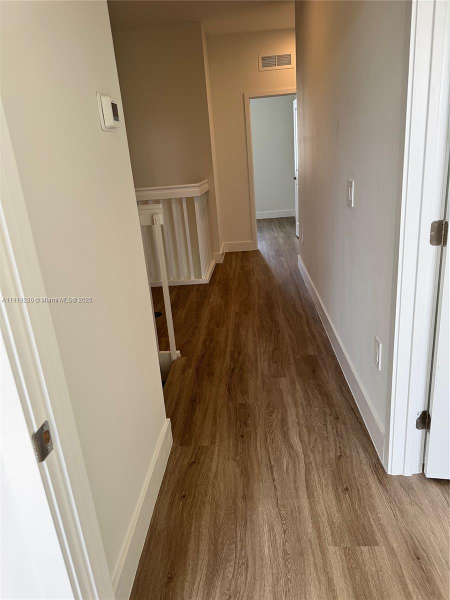 18932 Southwest 344th Terrace, Unit 18932 Homestead, FL 33034 - Photo 11 of 18 a view of stairs and wooden floor