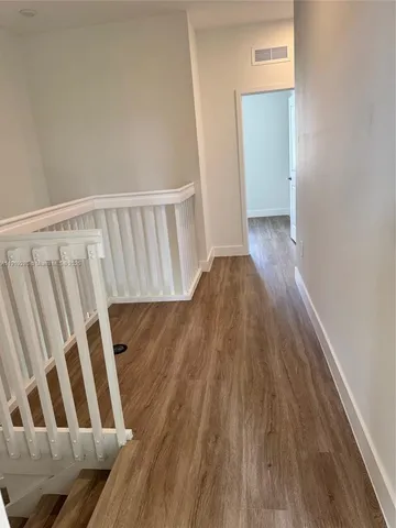a view of wooden floor and staircase