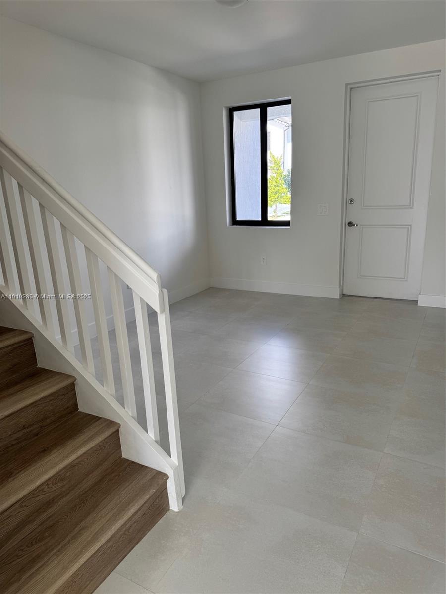 18932 Southwest 344th Terrace, Unit 18932 Homestead, FL 33034 - Photo 9 of 18 an empty room with windows