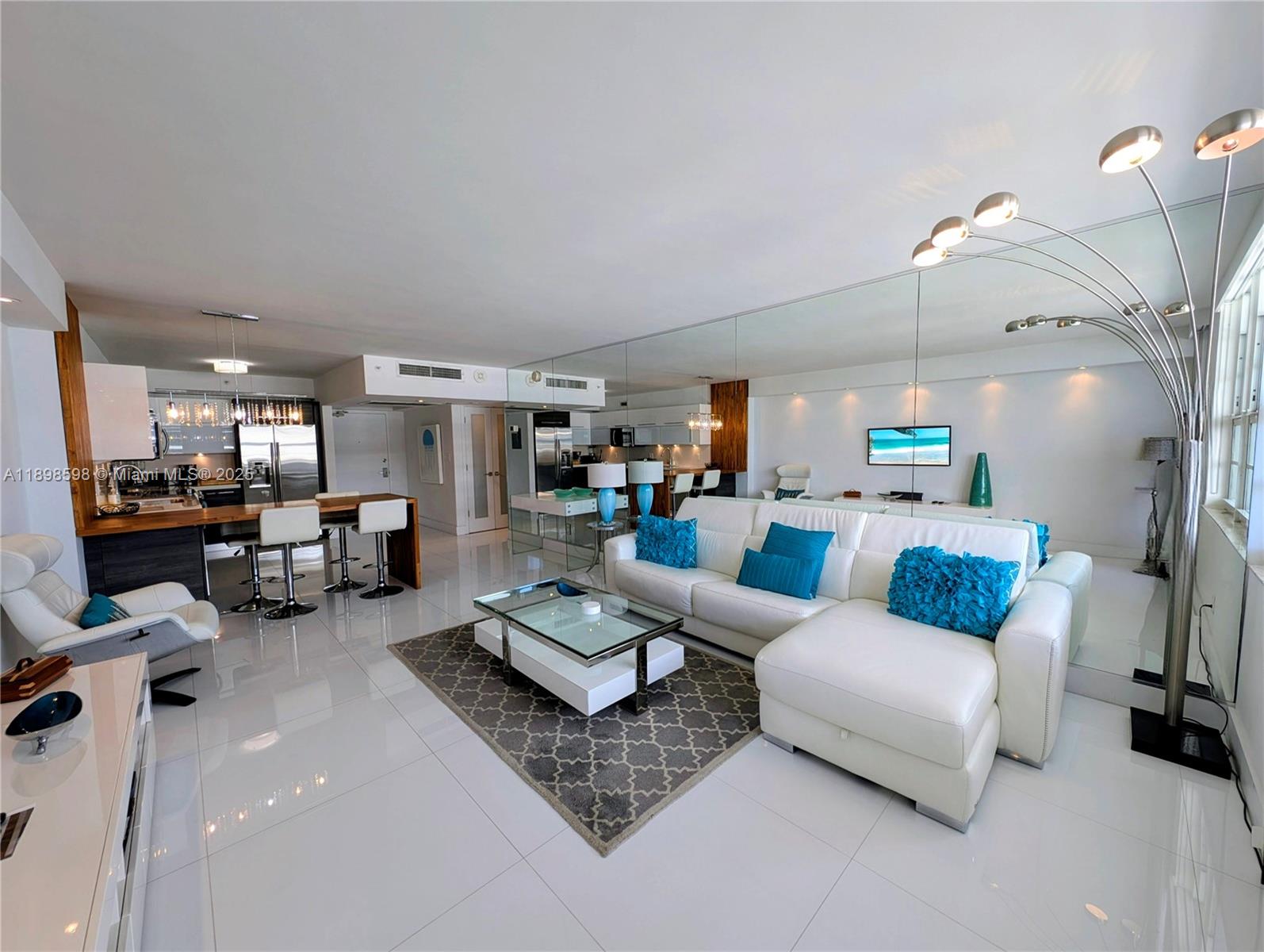 100 Lincoln Road, Unit 1008 Miami Beach, FL 33139 - Photo 1 of 13 a living room with furniture and a chandelier