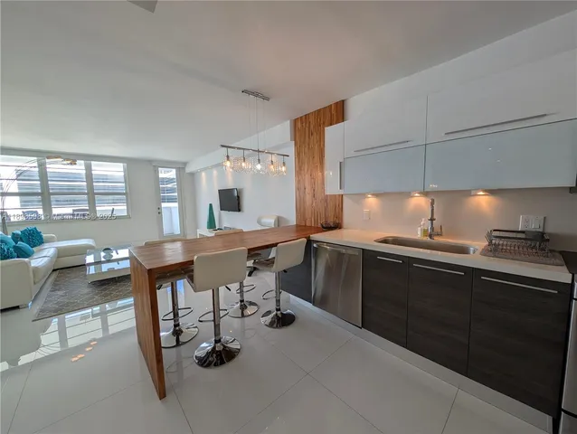 a kitchen with a sink cabinets and wooden floor
