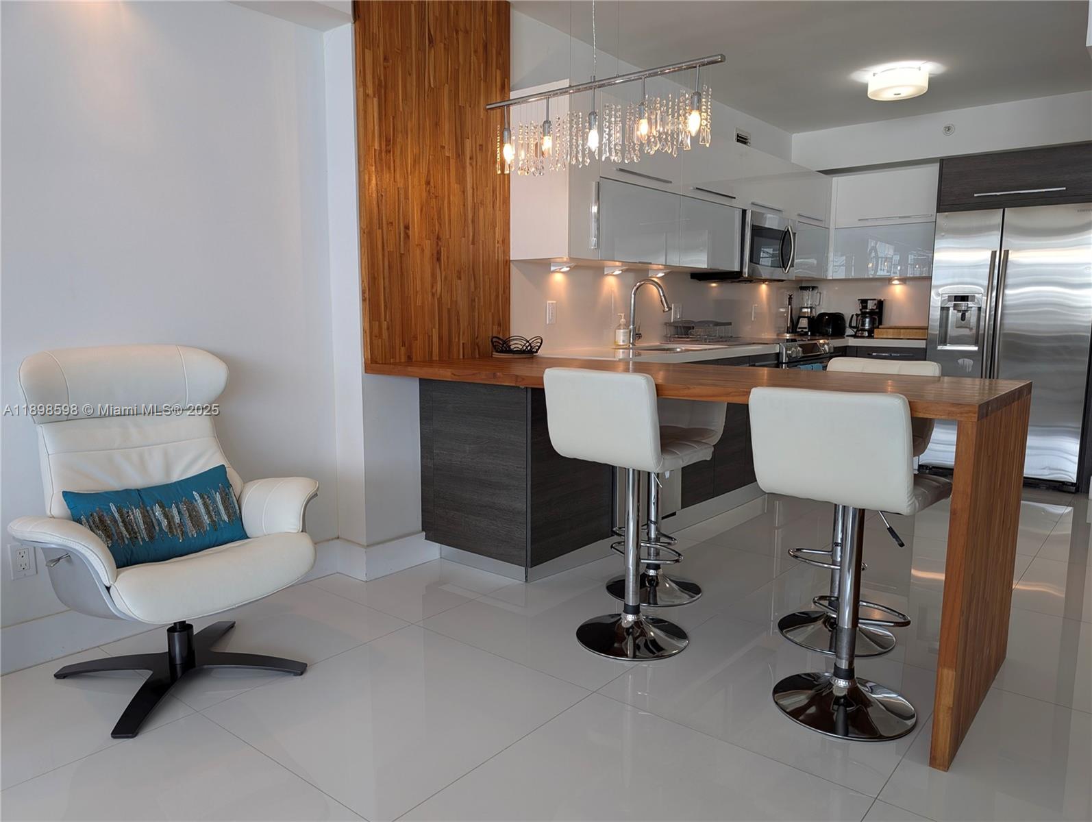 100 Lincoln Road, Unit 1008 Miami Beach, FL 33139 - Photo 4 of 13 a view of kitchen with dining area and chandelier