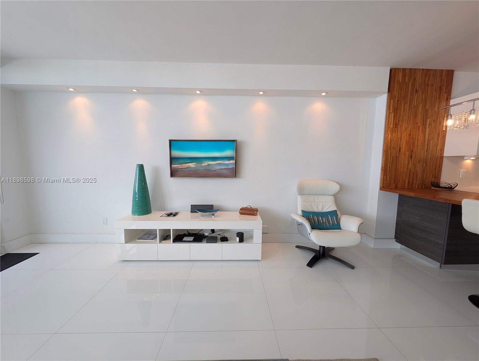 100 Lincoln Road, Unit 1008 Miami Beach, FL 33139 - Photo 5 of 13 a living room with furniture and a night stand