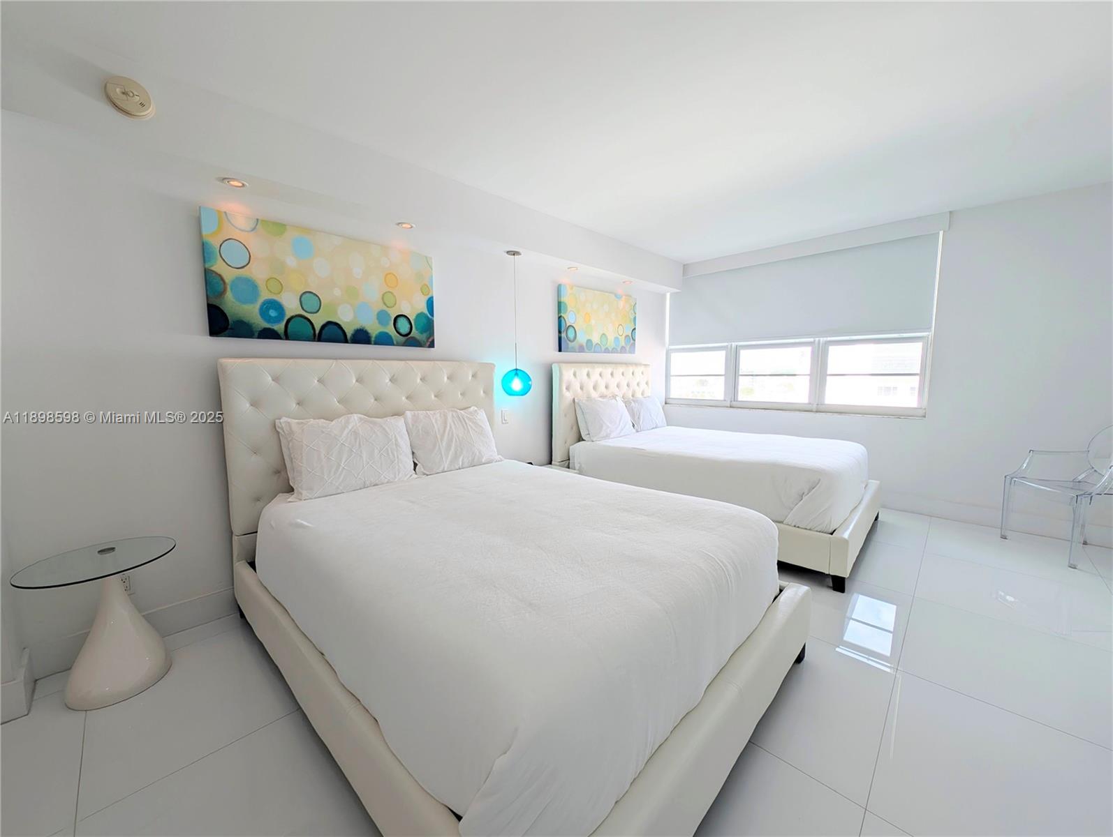 100 Lincoln Road, Unit 1008 Miami Beach, FL 33139 - Photo 6 of 13 a bedroom with a bed and window