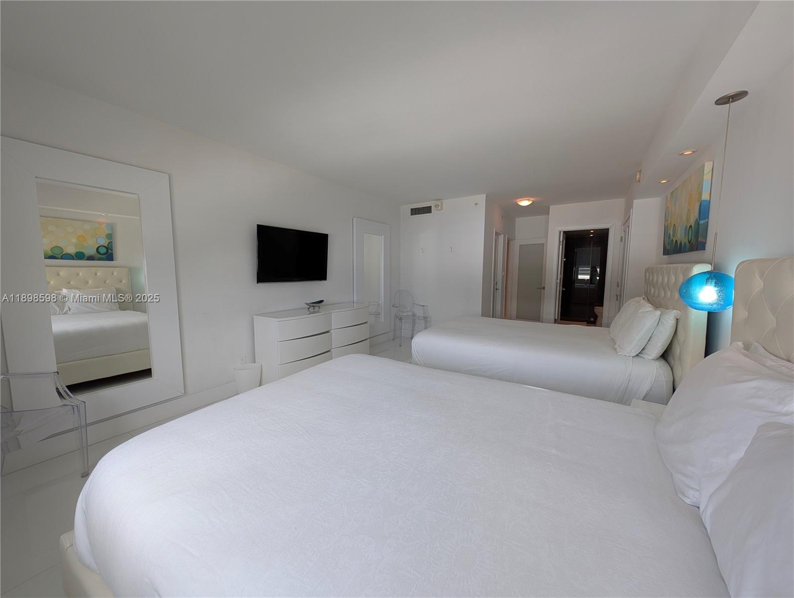 100 Lincoln Road, Unit 1008 Miami Beach, FL 33139 - Photo 7 of 13 a bedroom with a bed and a television