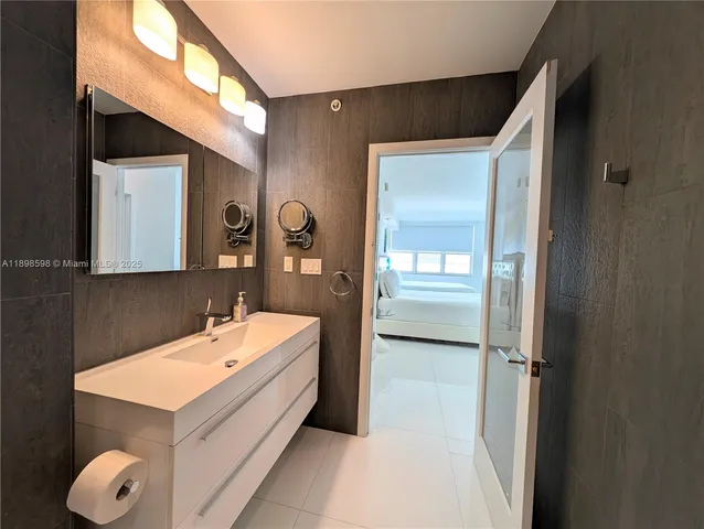 a bathroom with a sink and mirror