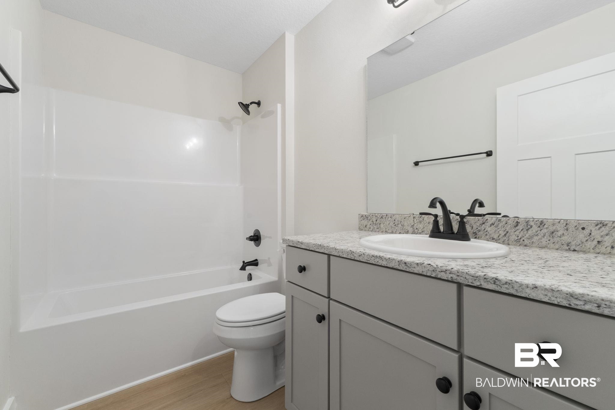 32563 Arbor Ridge Circle Lillian, AL 36549 - Photo 28 of 53 Full bath featuring vanity, bathing tub / shower combination, and light wood-type flooring