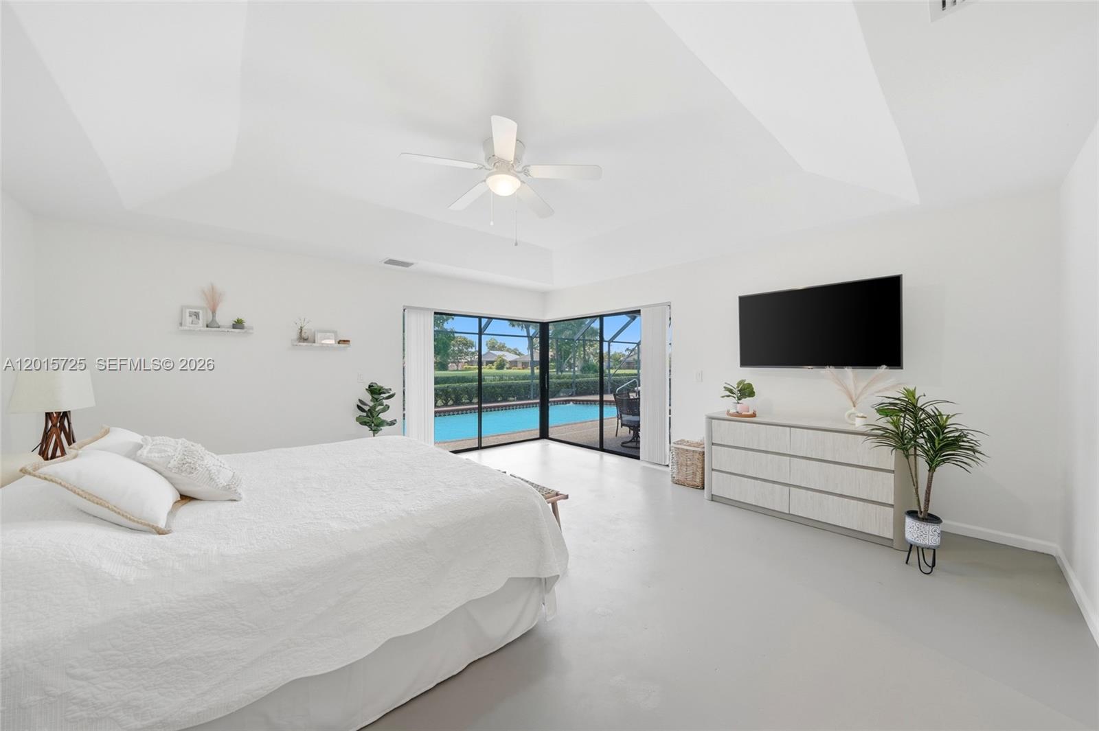 11008 Boca Woods Lane Boca Raton, FL 33428 - Photo 12 of 70 a bedroom with a bed flat screen tv and a large window