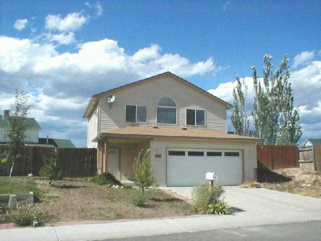 1557 Beech Street Rifle, CO 81650 - Photo 1 of 3 a front view of a house with a yard