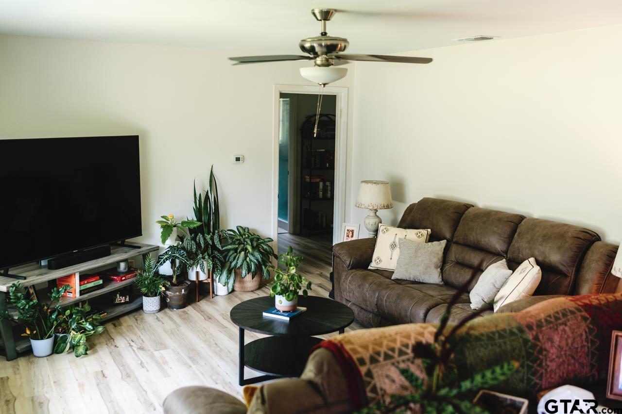 2411 Rodge Drive Tyler, TX 75701 - Photo 9 of 42 a living room with furniture and a flat screen tv