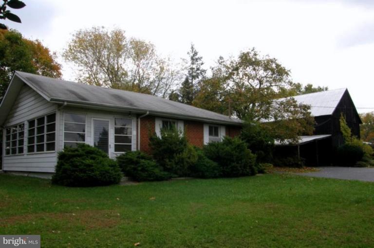 6005 Brooklyn Bridge Road Laurel, MD 20707 - Photo 1 of 1 a view of a house with brick walls and a yard with plants