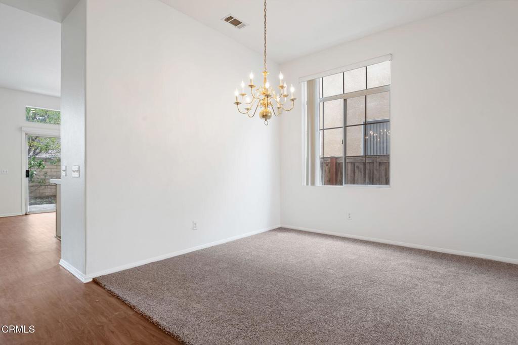 1930 Del Amo Way Oxnard, CA 93036 - Photo 8 of 31 an empty room with windows and chandelier