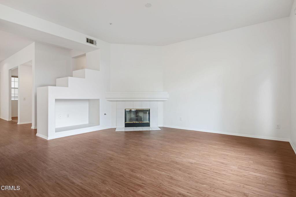 1930 Del Amo Way Oxnard, CA 93036 - Photo 10 of 31 a view of an empty room with wooden floor and a fireplace