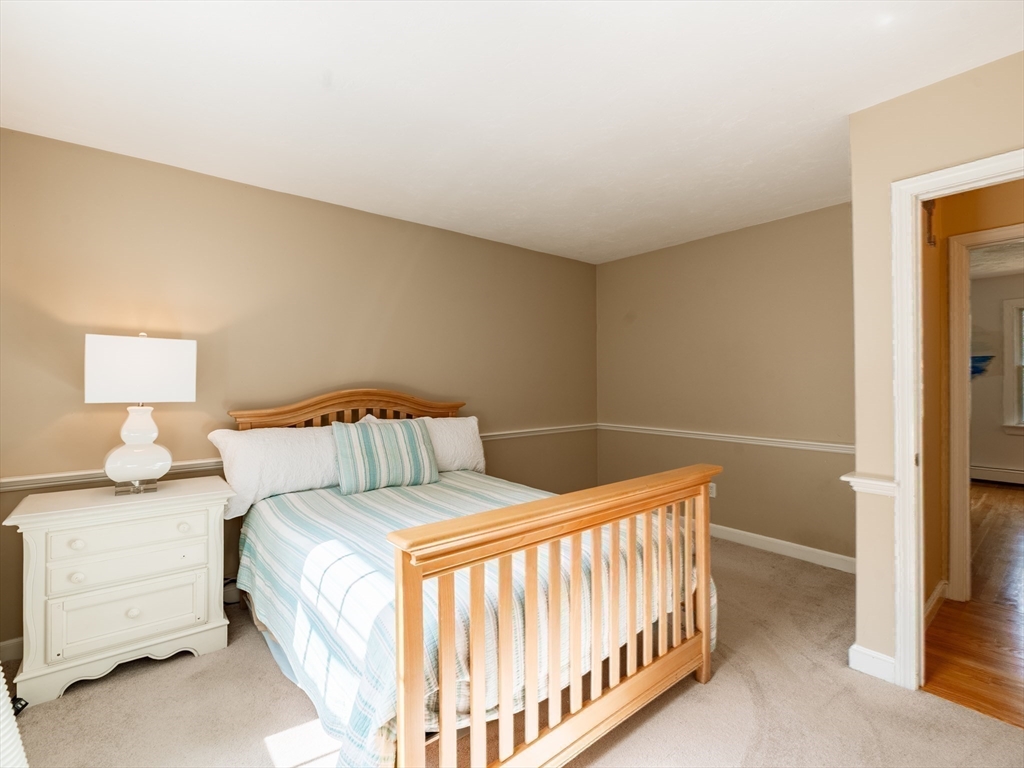 17 Gardner Road Duxbury, MA 02332 - Photo 33 of 42 a bedroom with a bed and a lamp