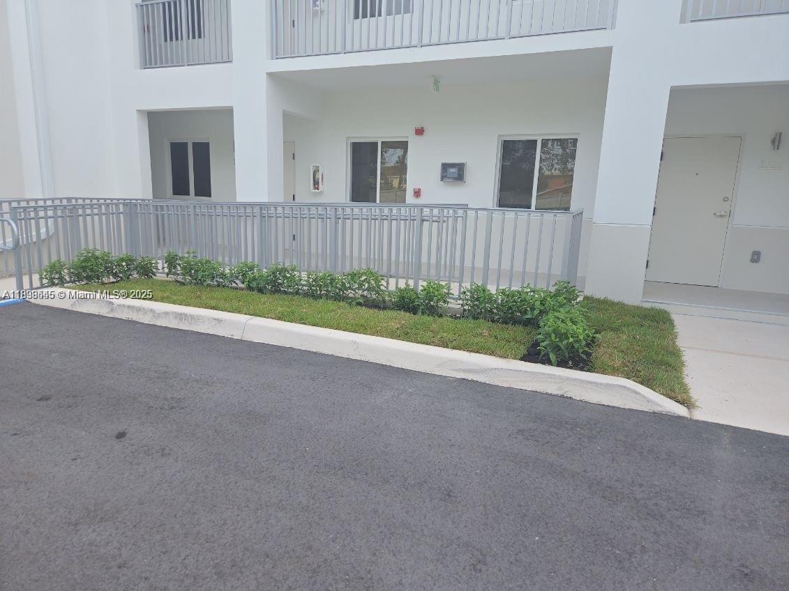 310 East 7th Street, Unit 204 Hialeah, FL 33010 - Photo 2 of 13 front view of a house with a yard