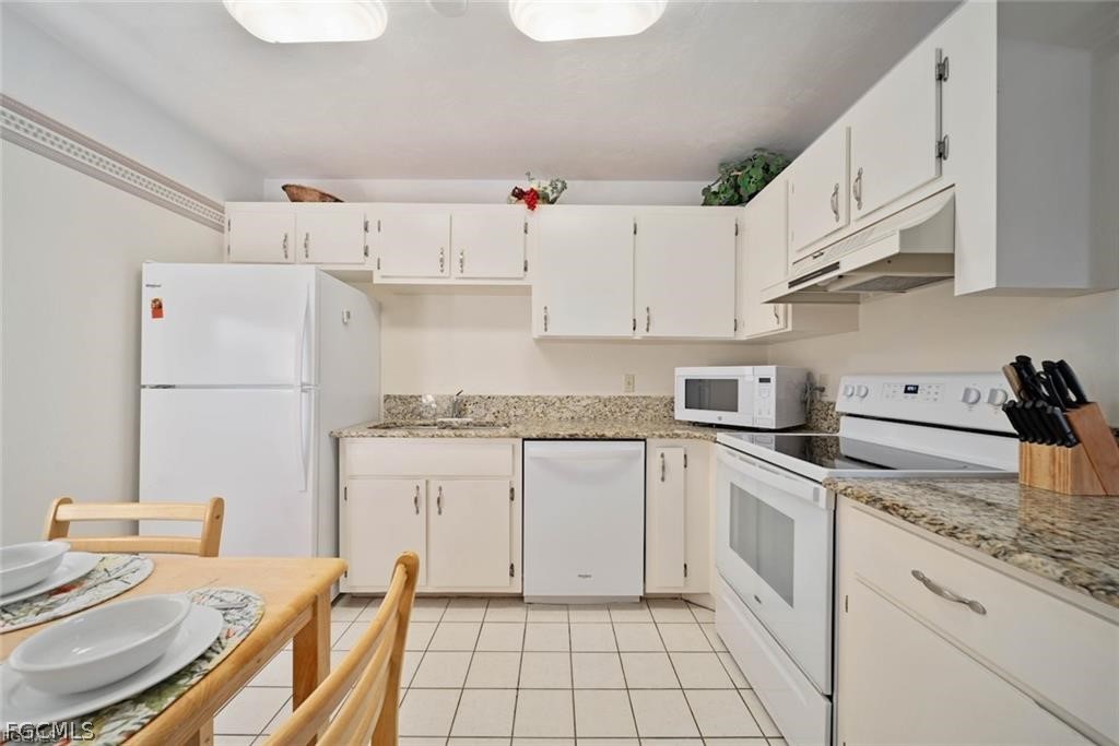 5117 Sea Bell Road, Unit F206 Sanibel, FL 33957 - Photo 28 of 47 a kitchen with cabinets and appliances