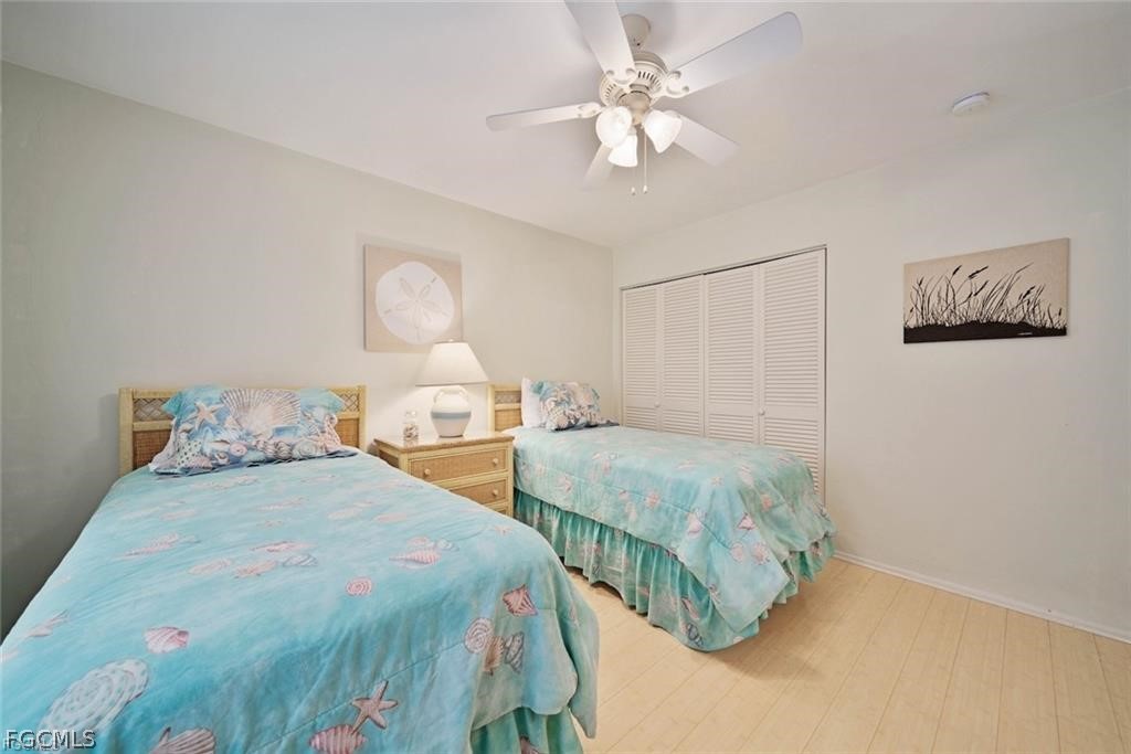 5117 Sea Bell Road, Unit F206 Sanibel, FL 33957 - Photo 36 of 47 a bedroom with double bed and a chandelier
