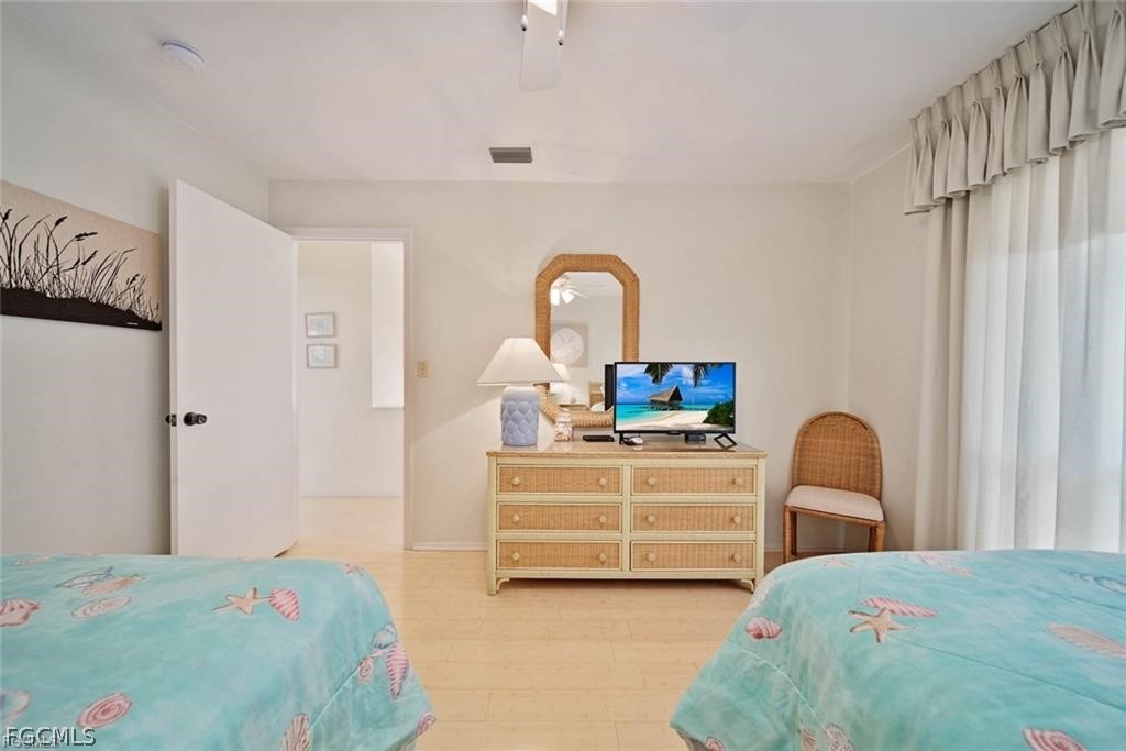5117 Sea Bell Road, Unit F206 Sanibel, FL 33957 - Photo 37 of 47 a bedroom with a bed and a dresser