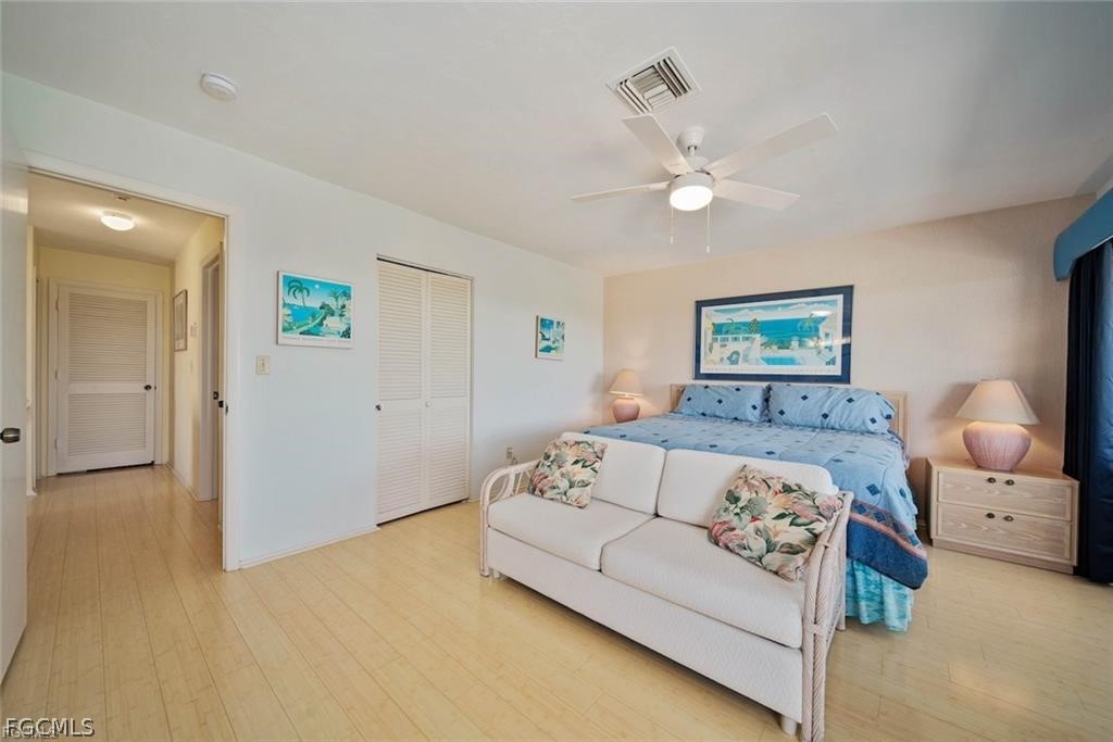 5117 Sea Bell Road, Unit F206 Sanibel, FL 33957 - Photo 39 of 47 a bedroom with a bed and a chandelier