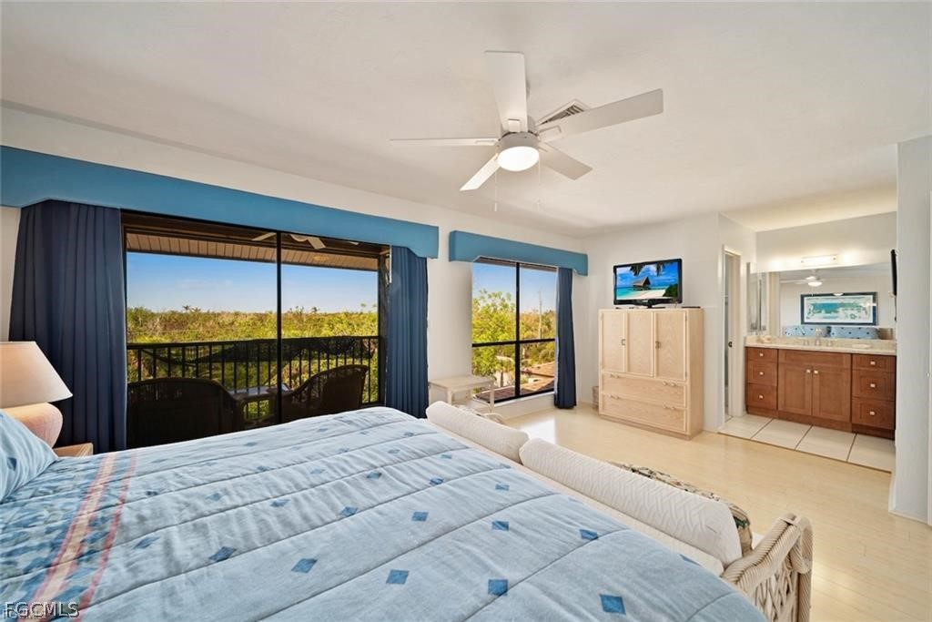 5117 Sea Bell Road, Unit F206 Sanibel, FL 33957 - Photo 40 of 47 a bedroom with a large bed and a large window with outer view