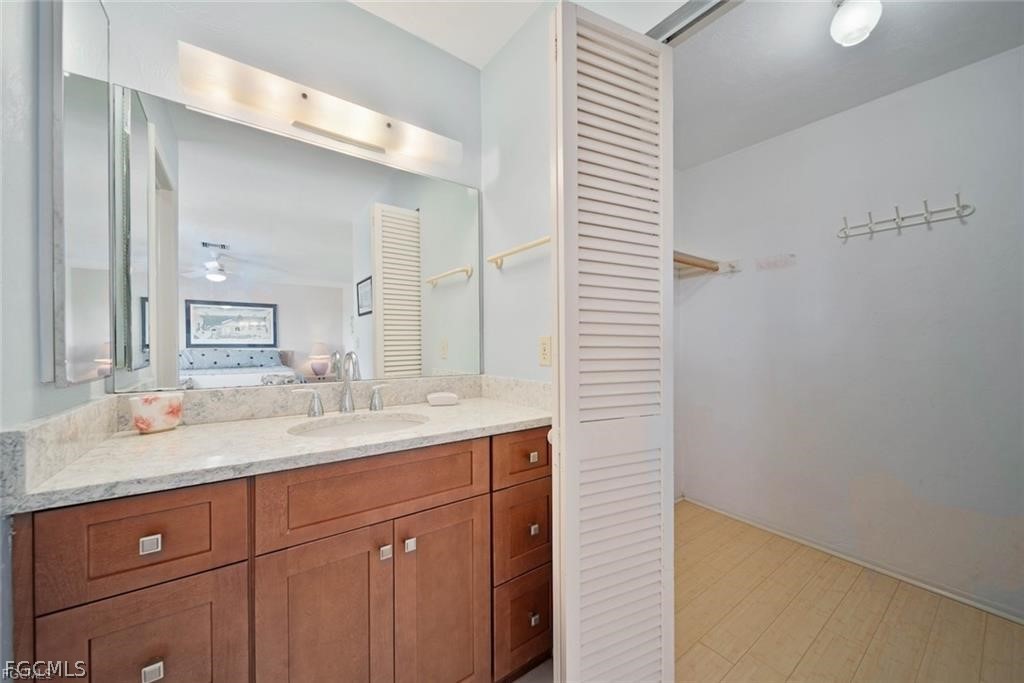 5117 Sea Bell Road, Unit F206 Sanibel, FL 33957 - Photo 45 of 47 a bathroom with a granite countertop sink and a mirror