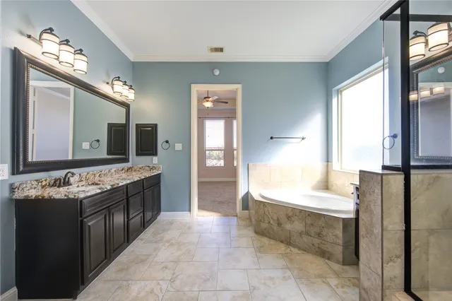 a large bathroom with a large tub and sink