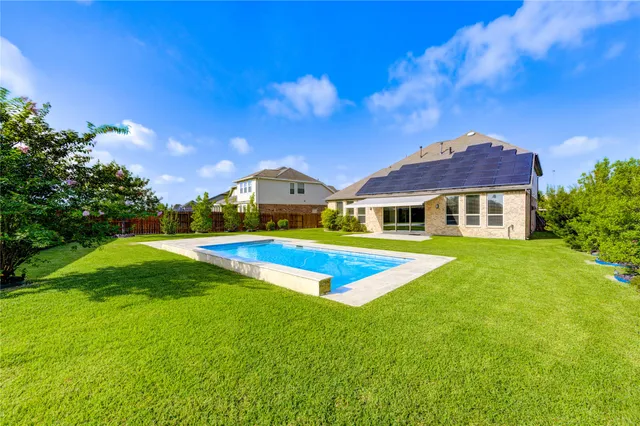 a front view of house with yard and swimming pool