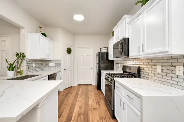 a kitchen with a stove a sink and a microwave