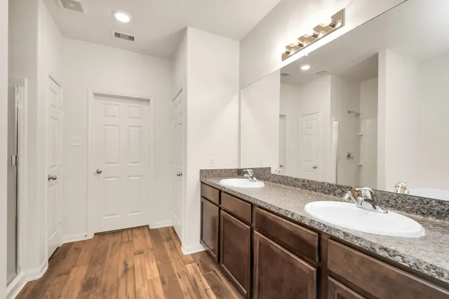a bathroom with a granite countertop sink and a mirror