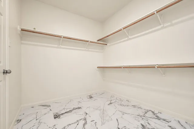 an empty room with fan and a ceiling fan