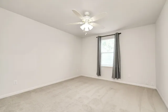 a view of a room with shelves and wooden floor